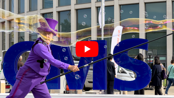 Bubble artist in front of large CMS letters